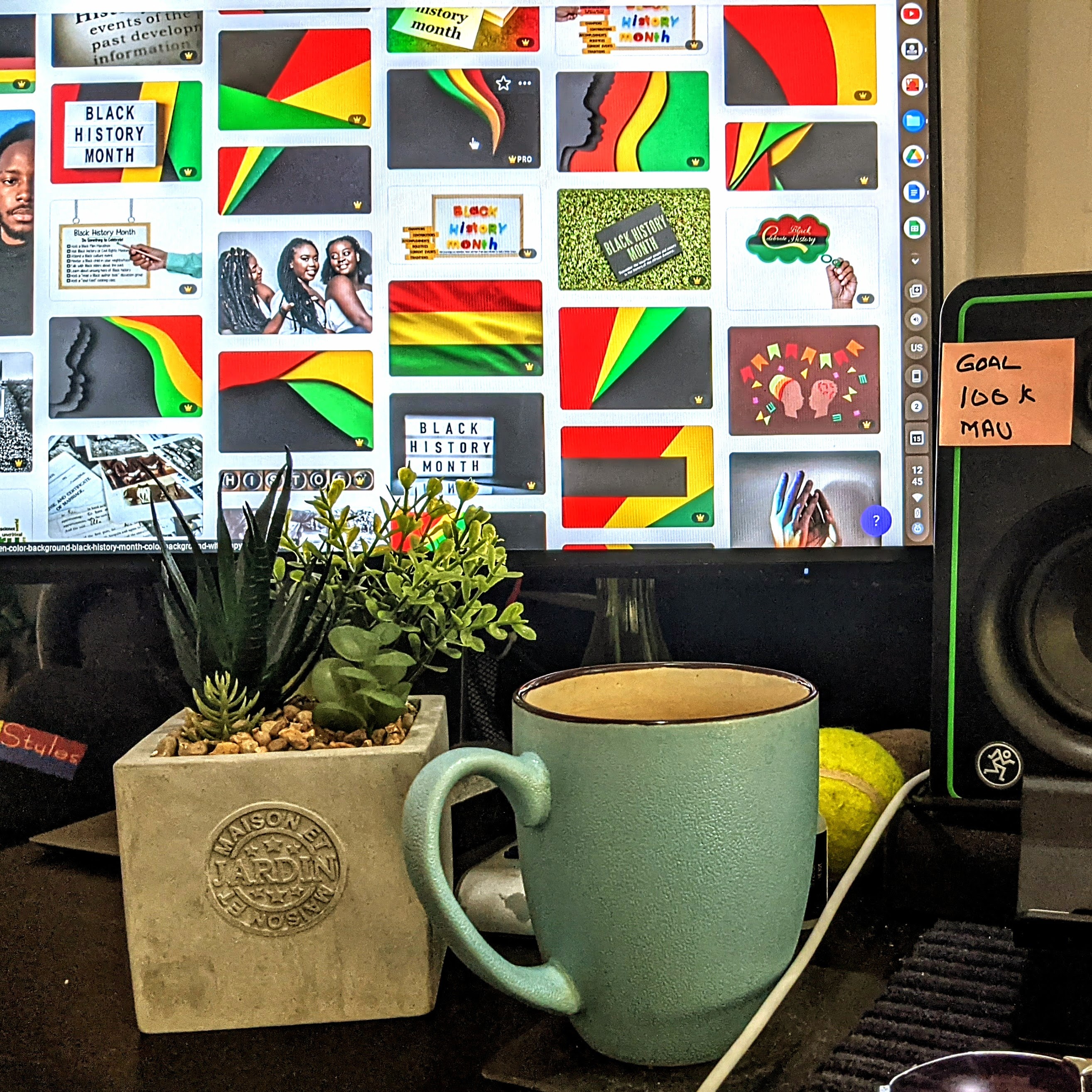My Desktop 20230315 Photo of a plant and coffee mug infront of a computer screen.